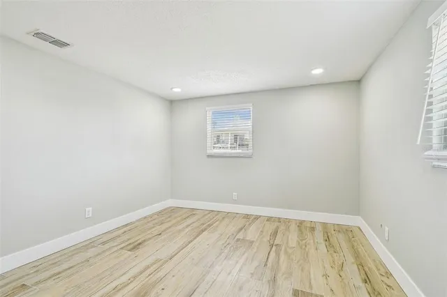 an aerial view of a house with a yard and lake view