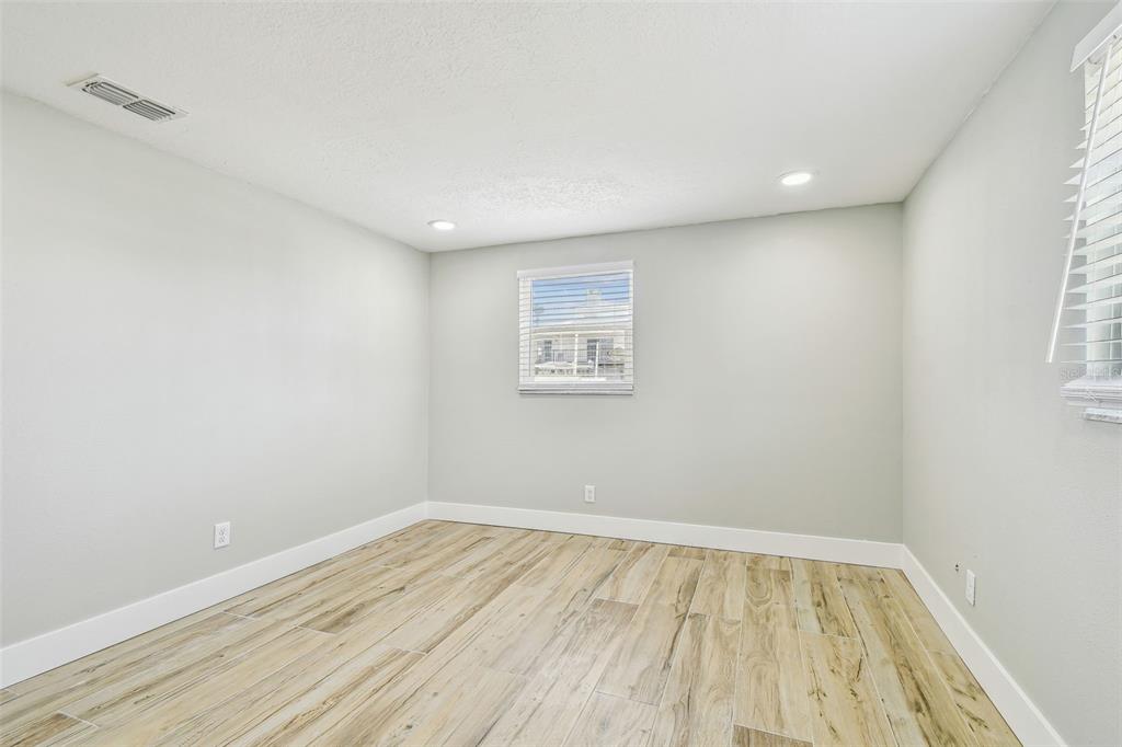 13909 Berkowitz Avenue Hudson, FL 34667 - Photo 50 of 91 an empty room with wooden floor and windows