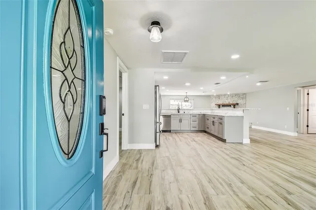a kitchen with stainless steel appliances granite countertop refrigerator sink and stove