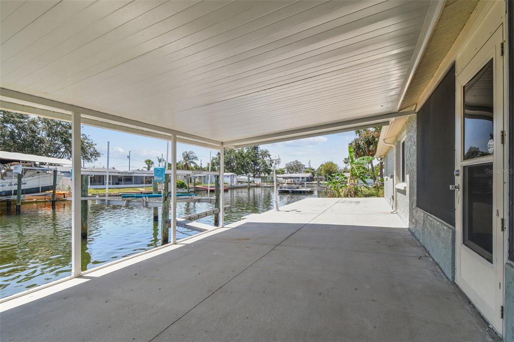 13909 Berkowitz Avenue Hudson, FL 34667 - Photo 68 of 91 a view of swimming pool with outdoor seating and plants