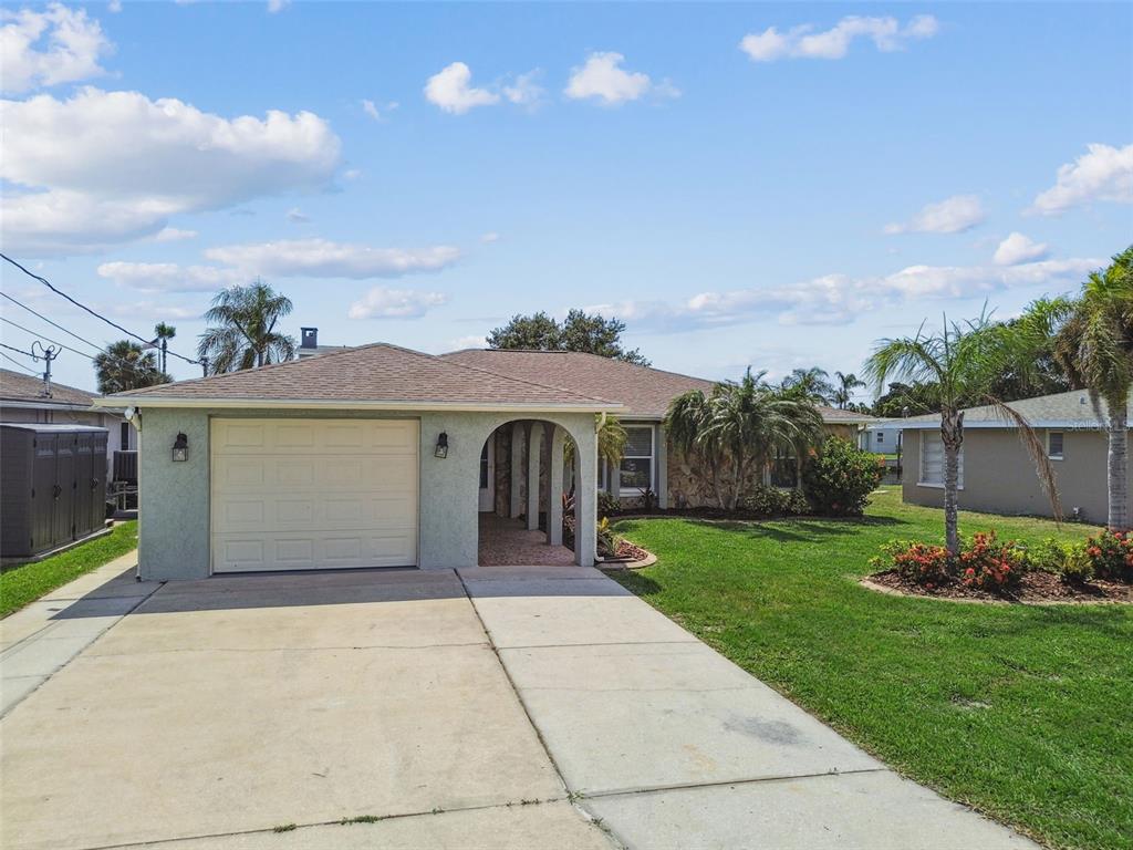 13909 Berkowitz Avenue Hudson, FL 34667 - Photo 71 of 91 a front view of a house with a garden