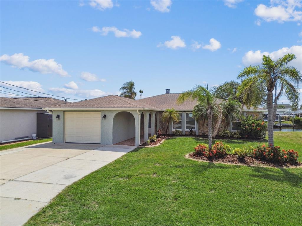 13909 Berkowitz Avenue Hudson, FL 34667 - Photo 73 of 91 a view of a house with a yard and potted plants