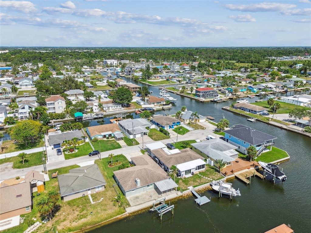 13909 Berkowitz Avenue Hudson, FL 34667 - Photo 86 of 91 an aerial view of residential houses with outdoor space and swimming pool