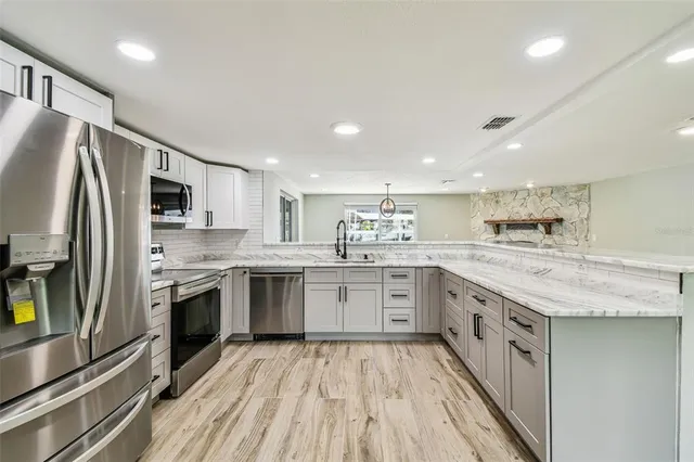 a kitchen with a stove microwave and sink