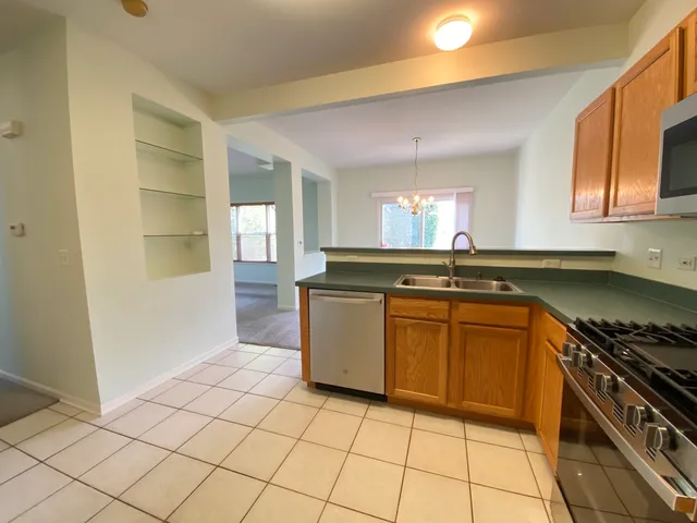 a kitchen with granite countertop a sink and a stove