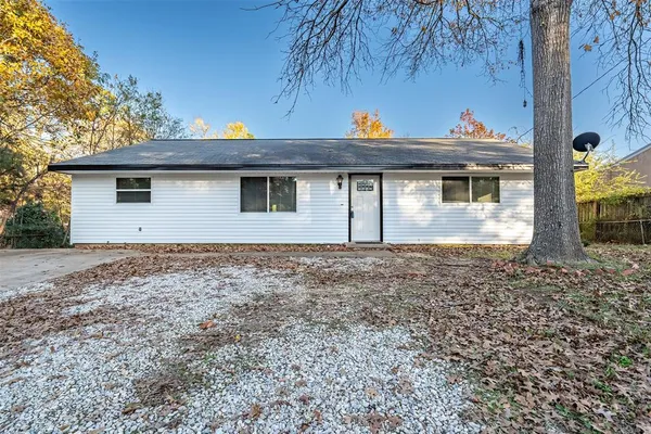 a view of a backyard with a tub and trees