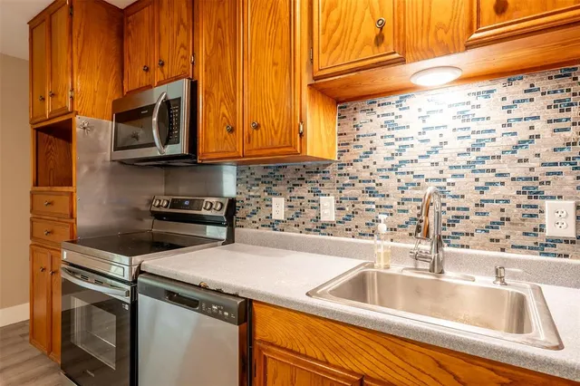 a kitchen with a sink and a microwave