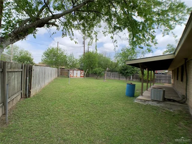an aerial view of a house with a backyard