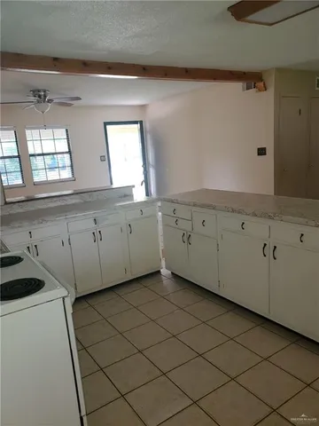 a view of a kitchen with white cabinets