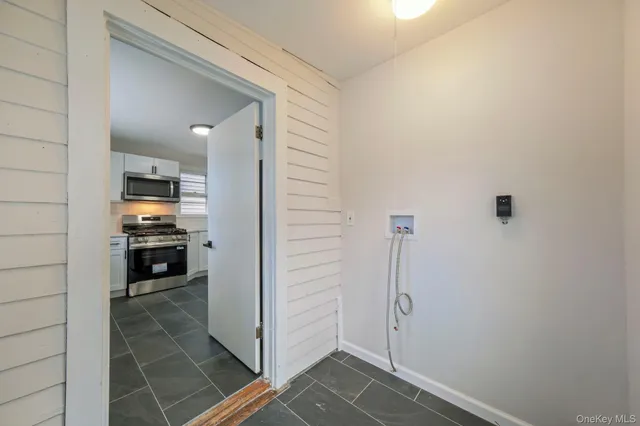 a view of a hallway view with wooden floor and living room