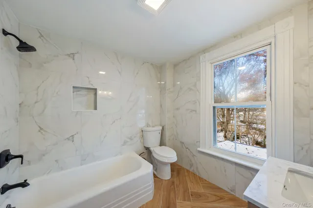 a bathroom with a bathtub and a shower