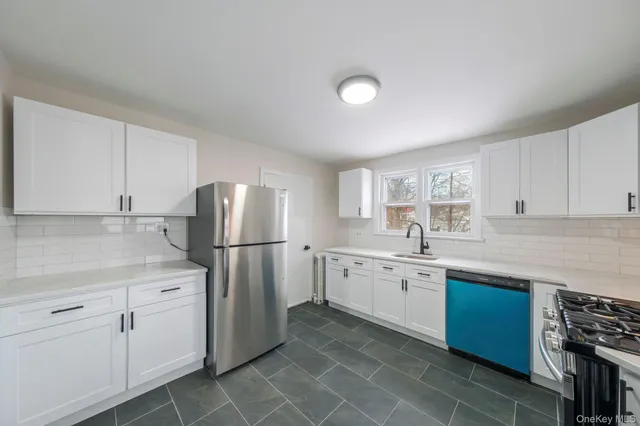 a kitchen with sink cabinets and window