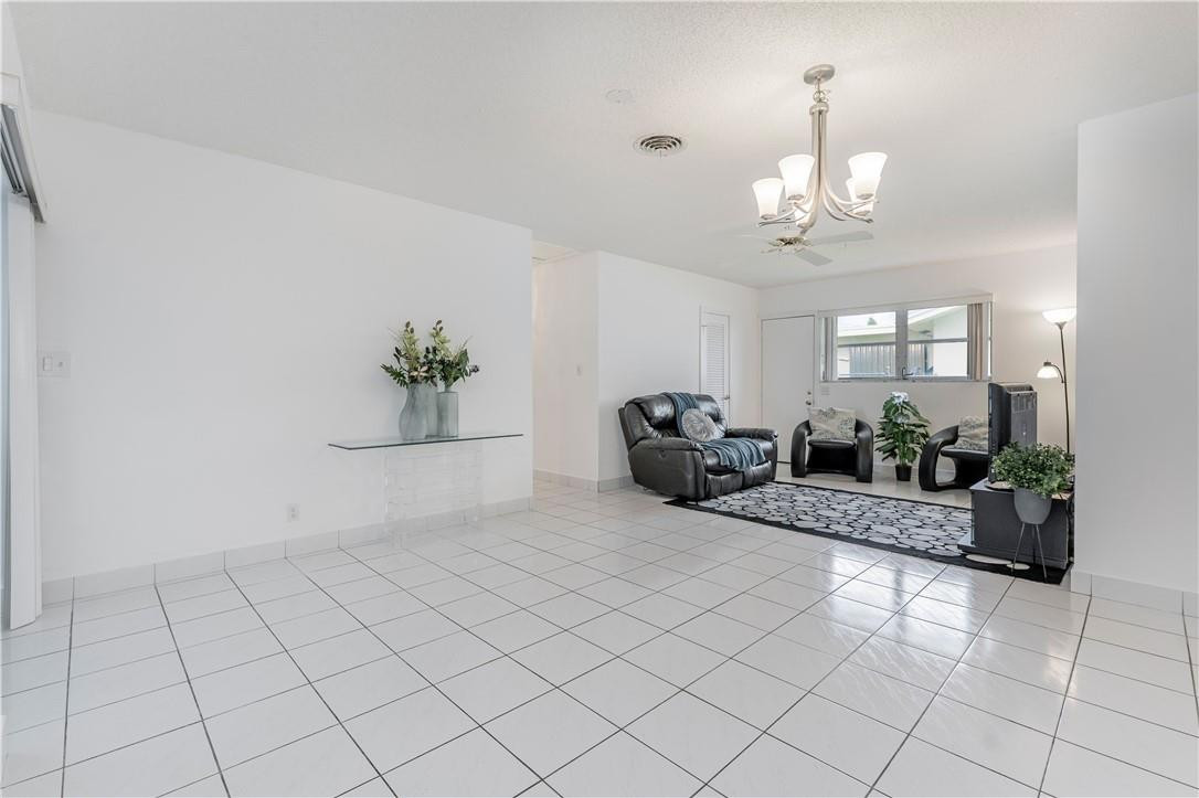 601 Northwest 12th Avenue Boca Raton, FL 33486 - Photo 13 of 27 a living room with furniture a chandelier and a chandelier