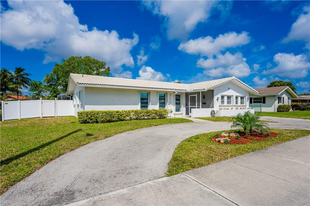 601 Northwest 12th Avenue Boca Raton, FL 33486 - Photo 2 of 27 a front view of a house with a yard and garage