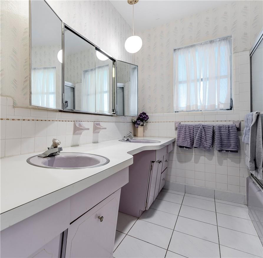 601 Northwest 12th Avenue Boca Raton, FL 33486 - Photo 21 of 27 a spacious bathroom with a sink a mirror and a bathtub