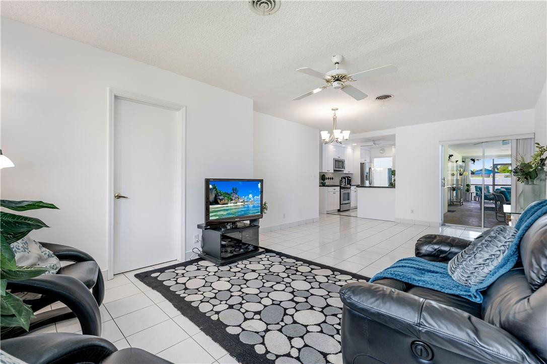 601 Northwest 12th Avenue Boca Raton, FL 33486 - Photo 23 of 27 a living room with furniture and a flat screen tv