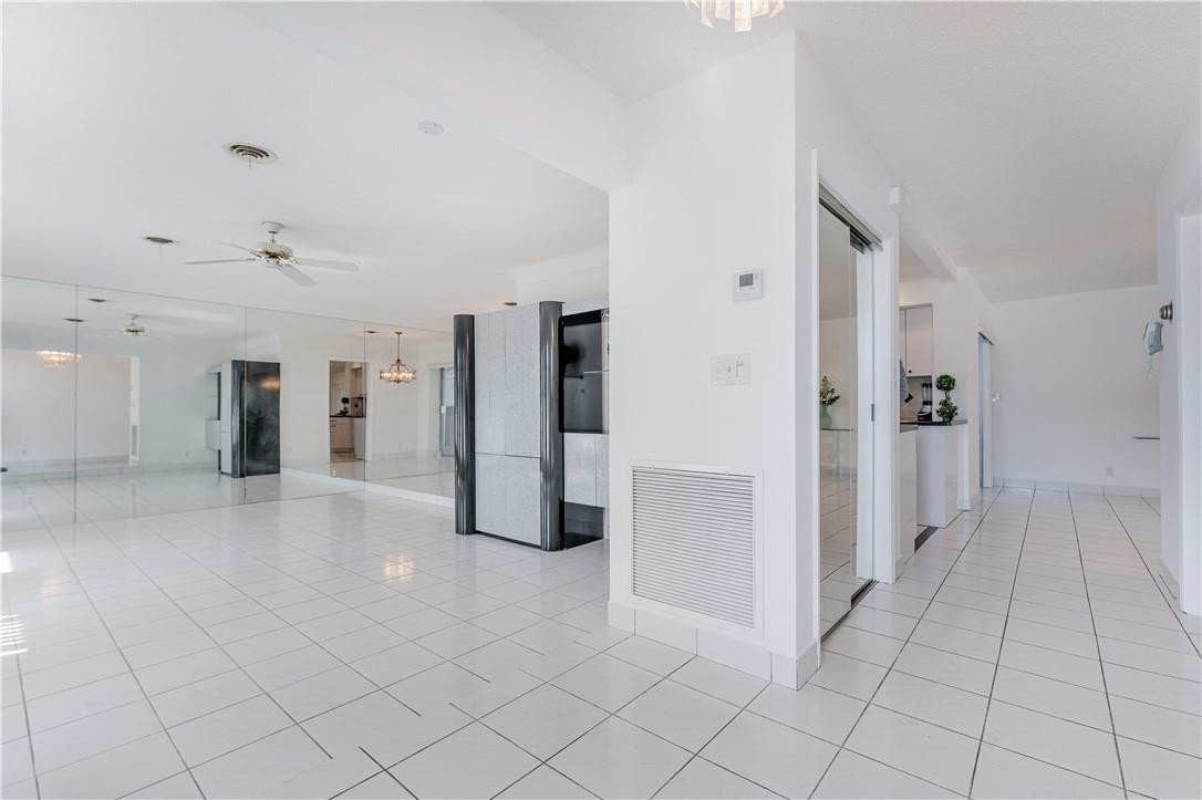 601 Northwest 12th Avenue Boca Raton, FL 33486 - Photo 6 of 27 a view of a refrigerator in kitchen and an empty room