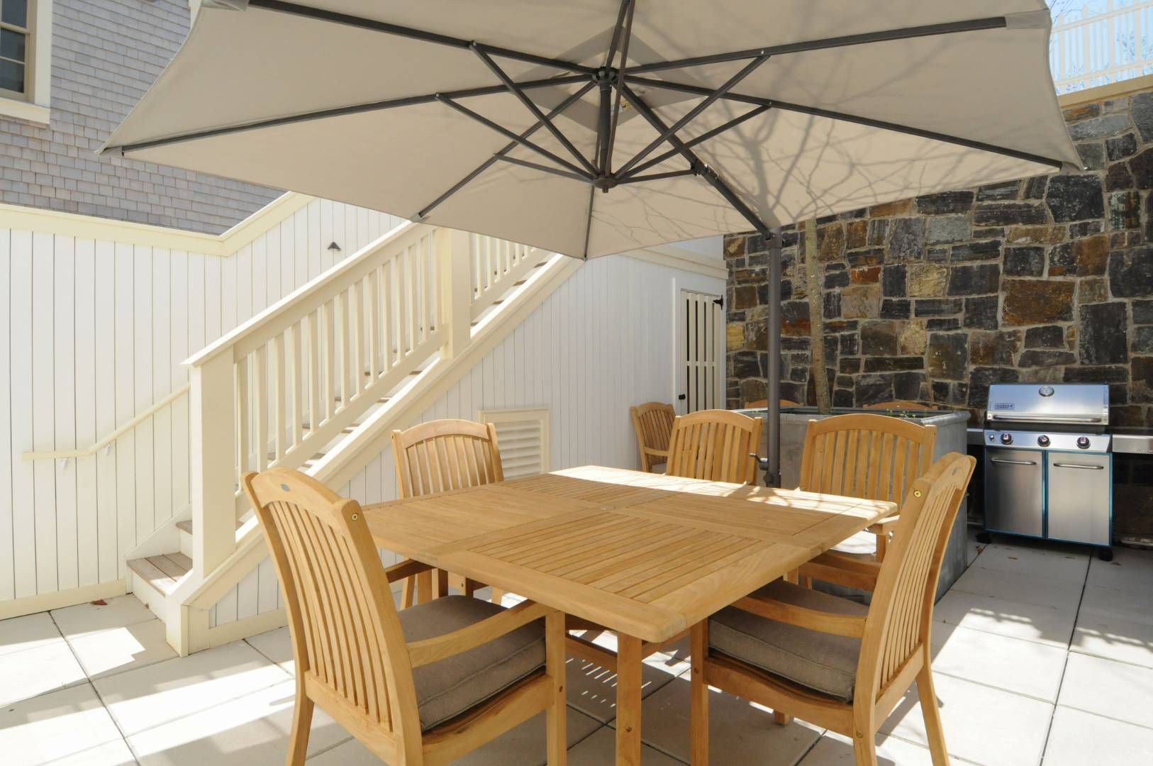 a view of a patio with a table and chairs