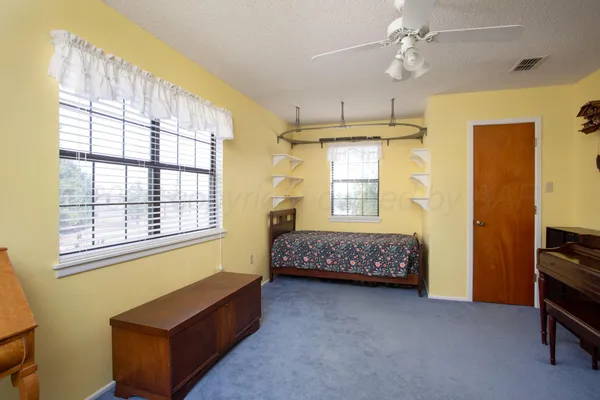 a spacious bedroom with a bed and a window