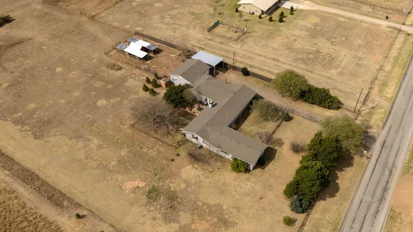 an aerial view of a house with a yard
