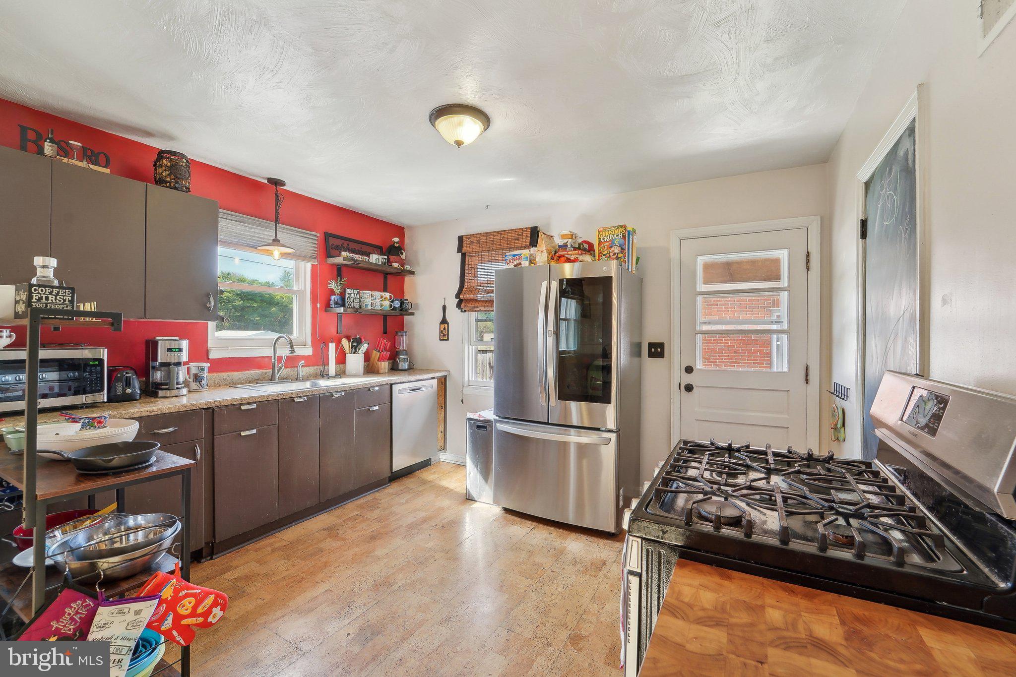414 Biggs Avenue Frederick, MD 21702 - Photo 13 of 27 a kitchen with sink refrigerator and stove