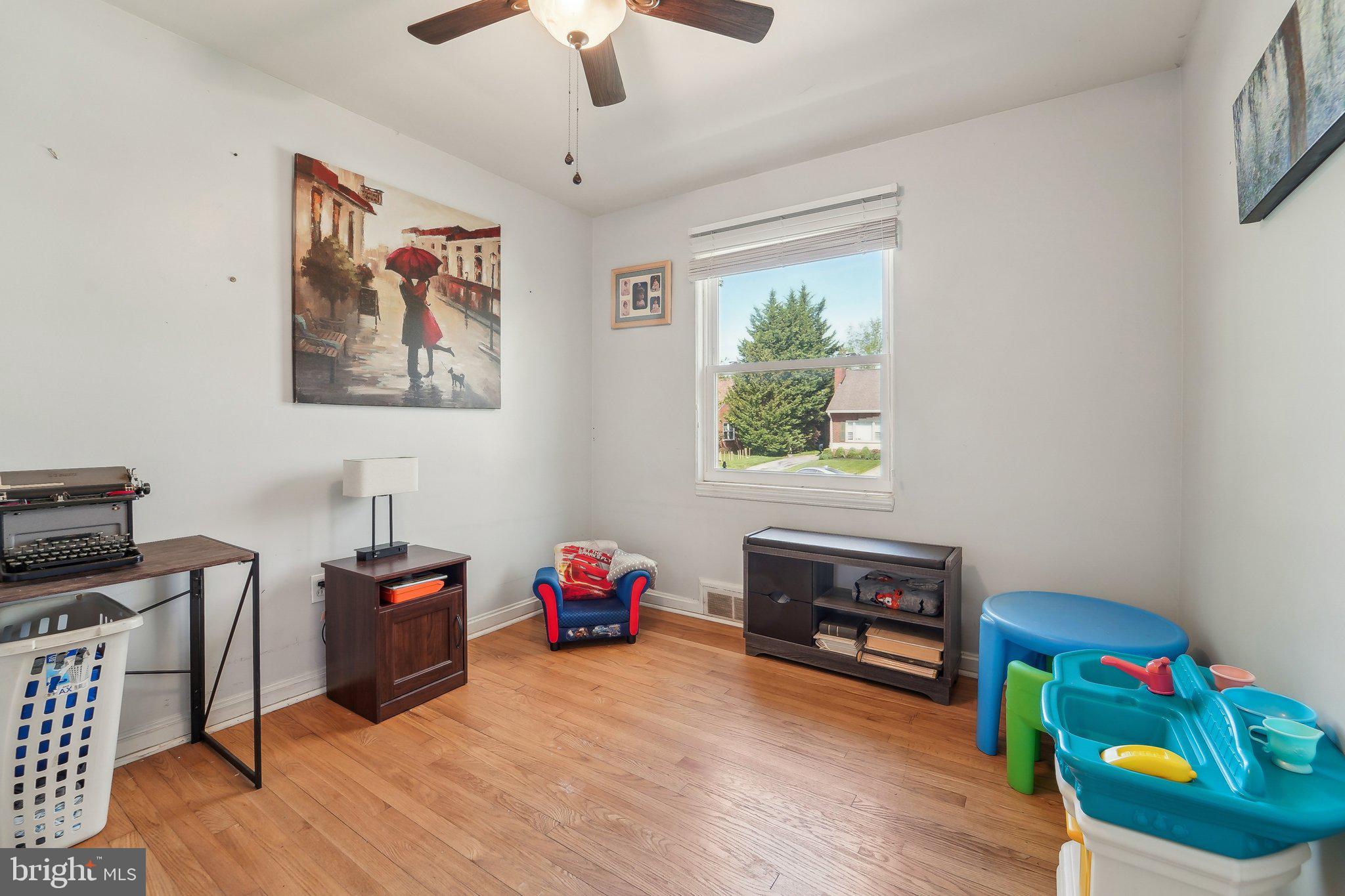 414 Biggs Avenue Frederick, MD 21702 - Photo 16 of 27 a bedroom with furniture and a wooden floor