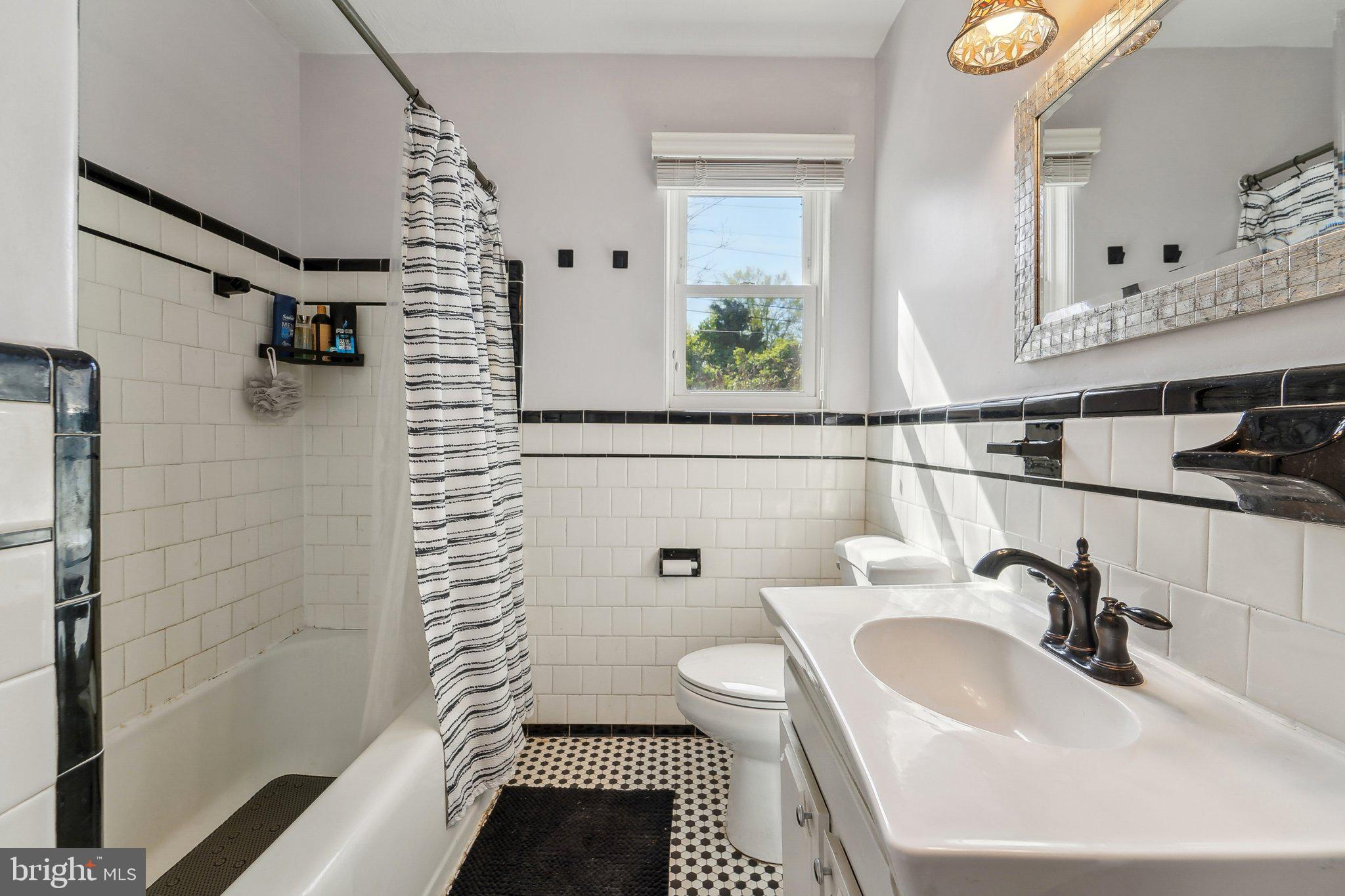 414 Biggs Avenue Frederick, MD 21702 - Photo 19 of 27 a bathroom with a sink a toilet and shower