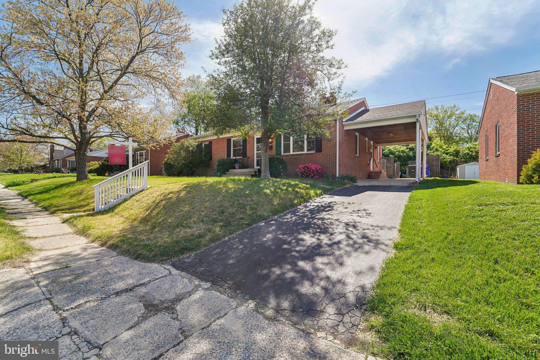 414 Biggs Avenue Frederick, MD 21702 - Photo 3 of 27 a front view of a house with a yard and trees