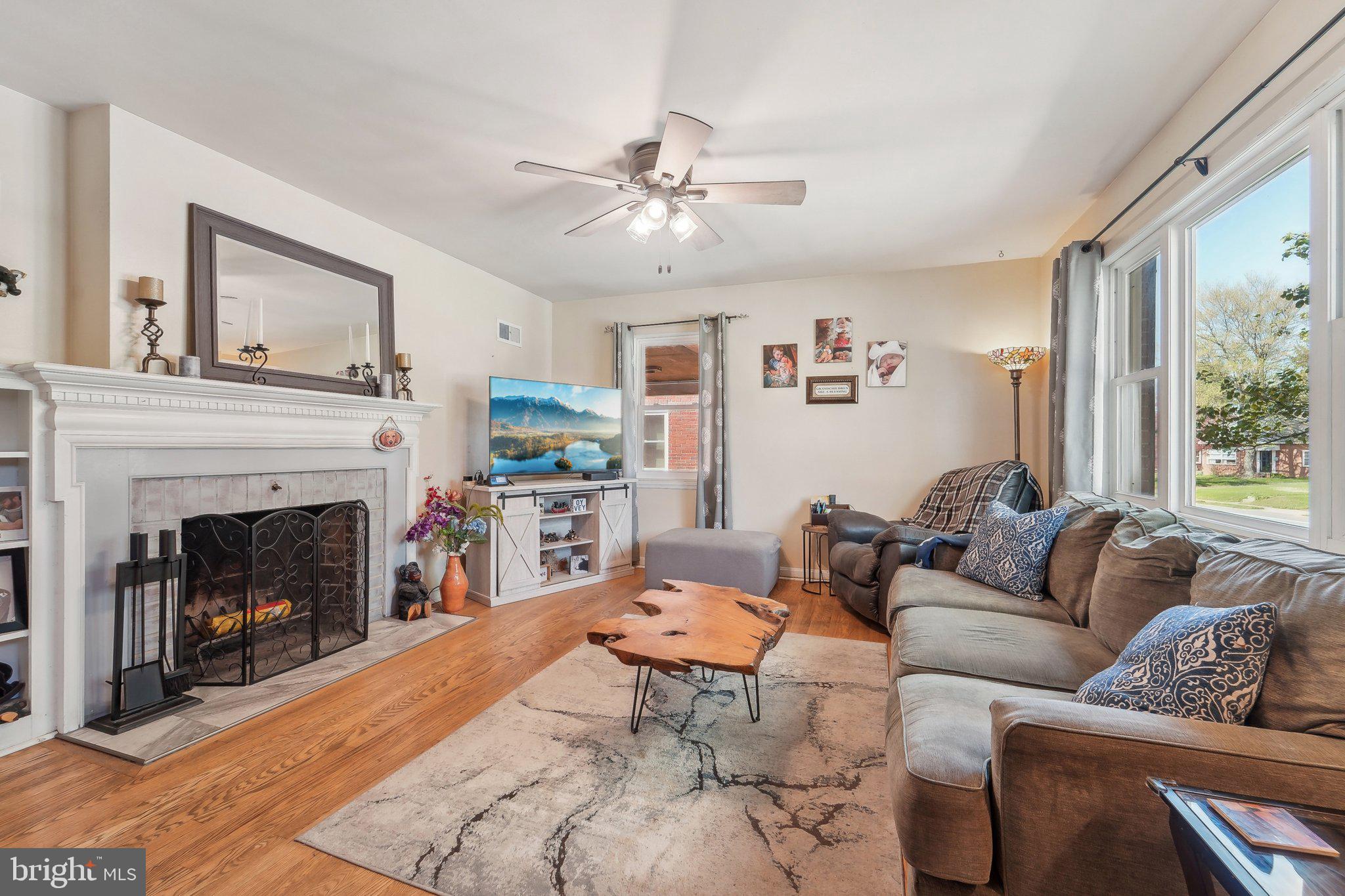 414 Biggs Avenue Frederick, MD 21702 - Photo 7 of 27 a living room with furniture and a fireplace