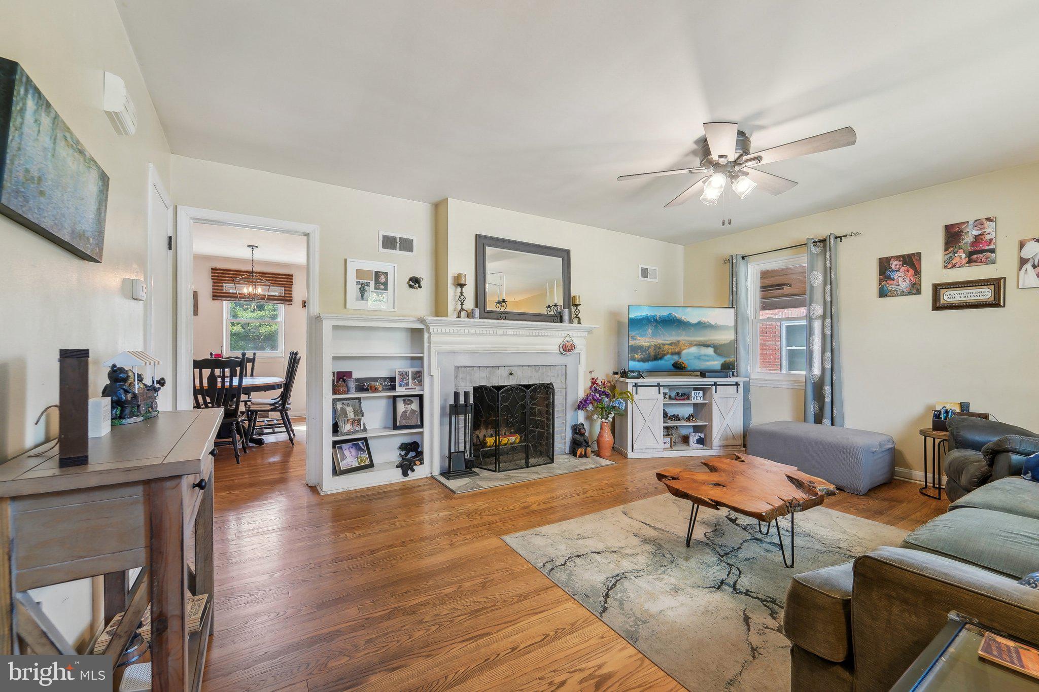 414 Biggs Avenue Frederick, MD 21702 - Photo 8 of 27 a living room with furniture a fireplace and wooden floor