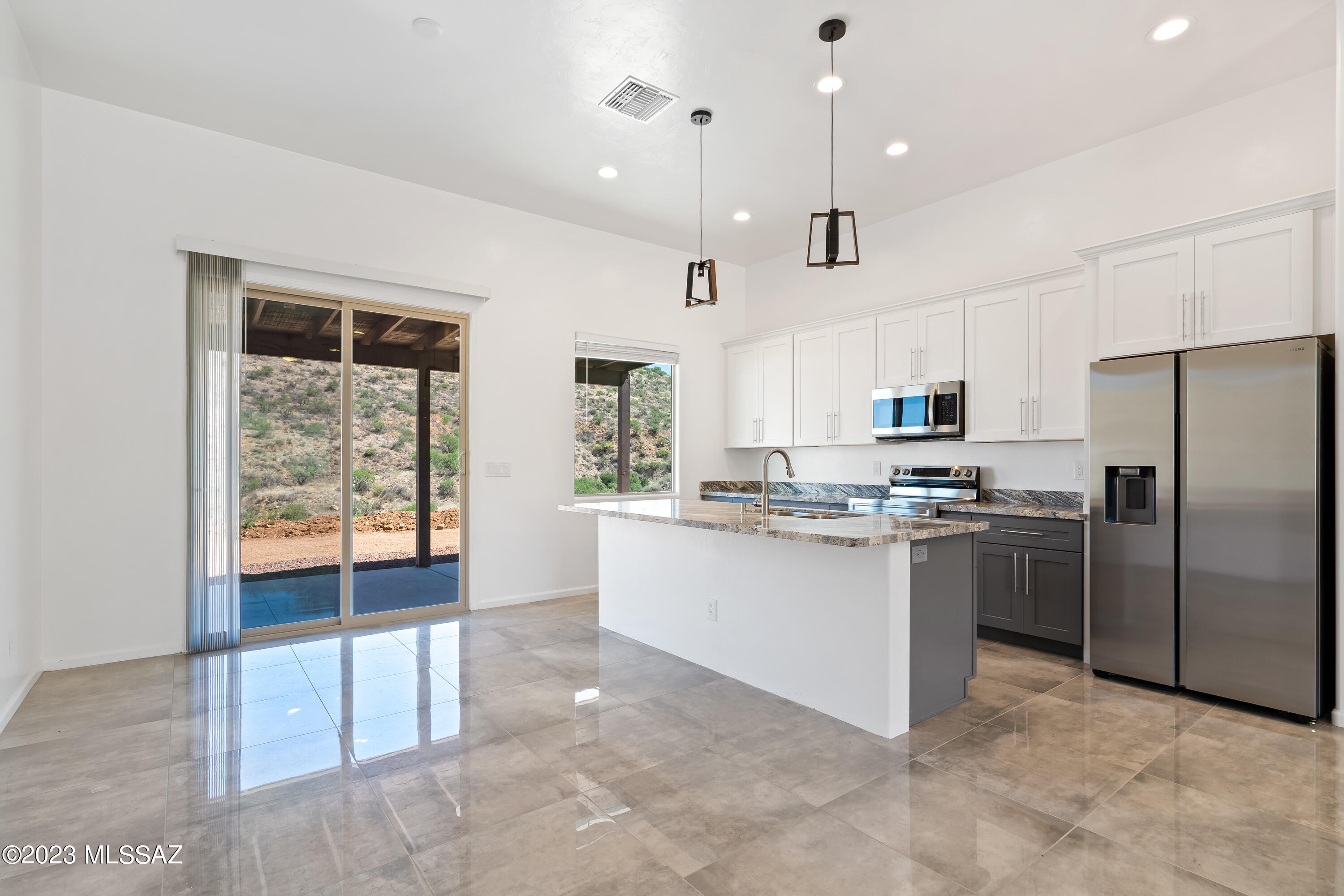 294 Circulo Cerro Rio Rico, AZ 85648 - Photo 8 of 38 a kitchen with stainless steel appliances granite countertop a stove a sink a refrigerator and white cabinets with wooden floor