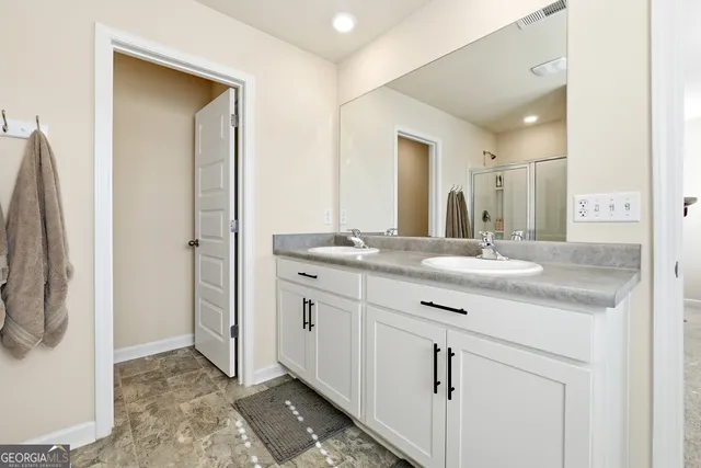 a bathroom with a granite countertop sink a mirror and a