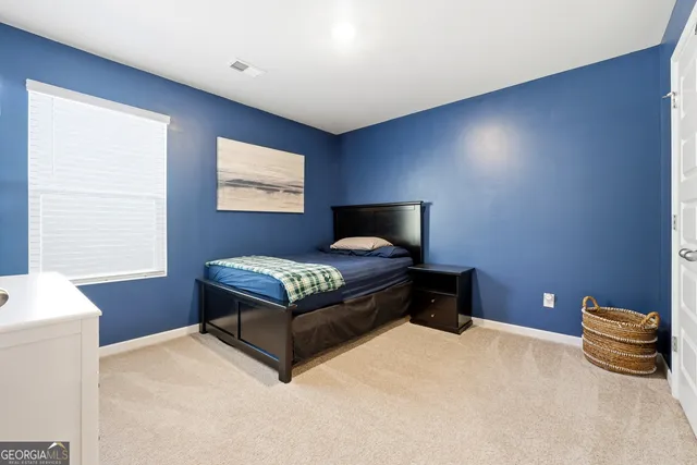 a bedroom with a bed and window