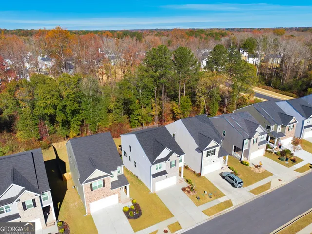 an aerial view of a house with garden space and ocean view