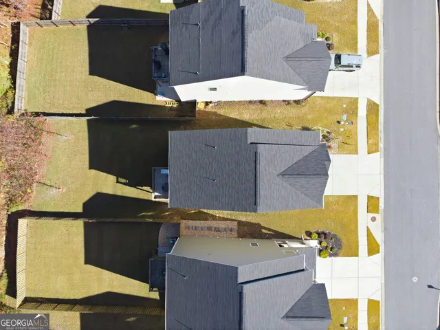 an aerial view of residential houses with yard
