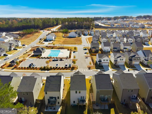 an aerial view of residential building and lake