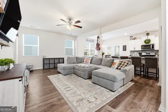 a living room with furniture and wooden floor