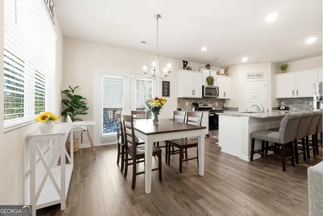 a view of a dining room with furniture and wooden floor