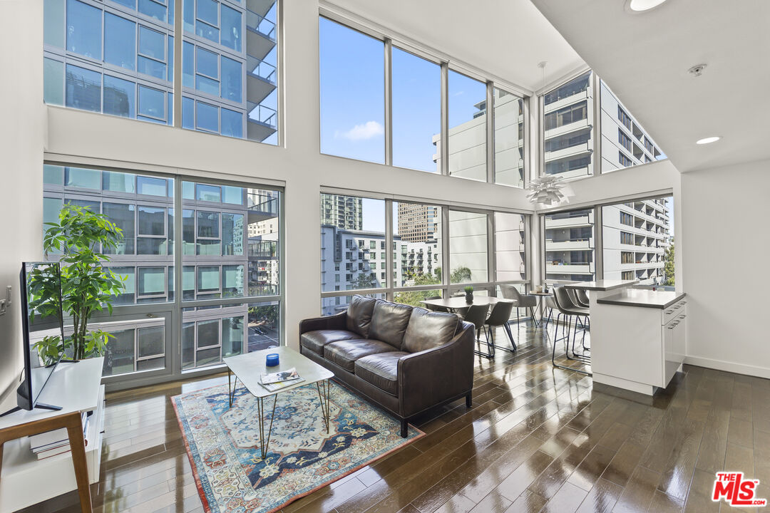 901 Flower Street, Unit 700 Los Angeles, CA 90015 - Photo 1 of 55 a living room with furniture and wooden floor
