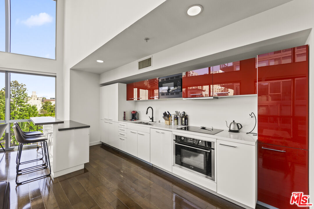 901 Flower Street, Unit 700 Los Angeles, CA 90015 - Photo 11 of 55 a kitchen with stainless steel appliances a stove a sink and a refrigerator