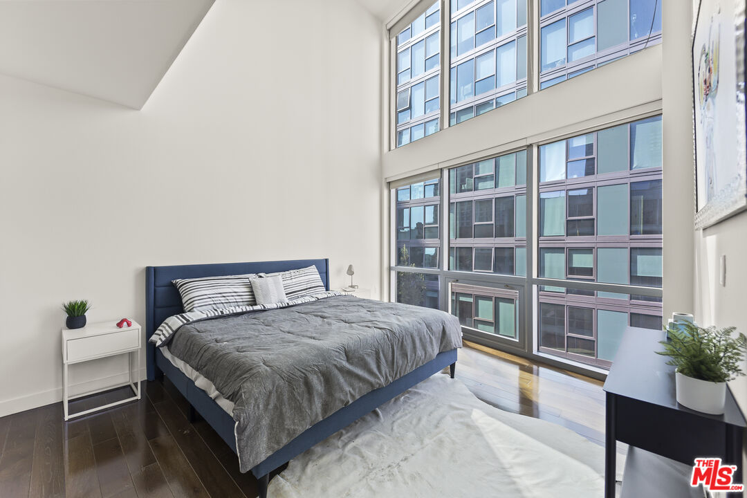 901 Flower Street, Unit 700 Los Angeles, CA 90015 - Photo 13 of 55 a large bed sitting in a bedroom next to a large window