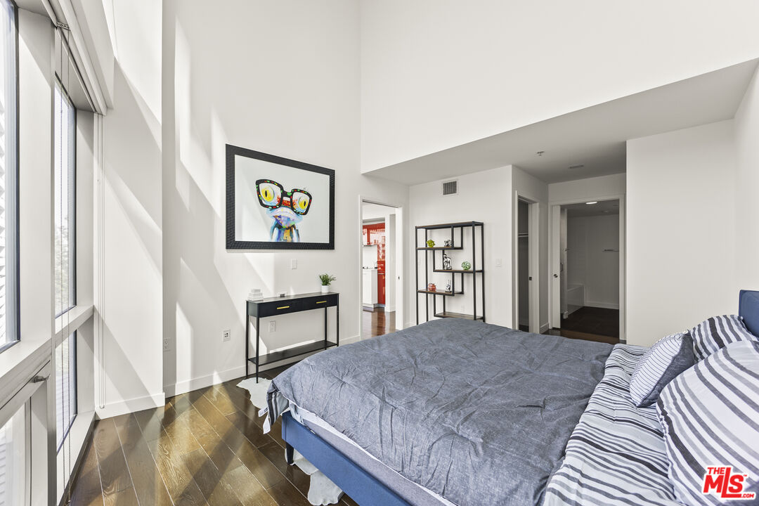 901 Flower Street, Unit 700 Los Angeles, CA 90015 - Photo 15 of 55 a bedroom with a bed and a cabinets