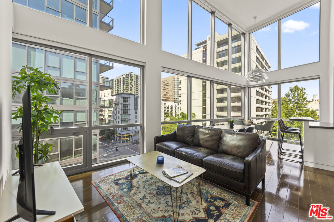901 Flower Street, Unit 700 Los Angeles, CA 90015 - Photo 2 of 55 a living room with furniture and floor to ceiling windows