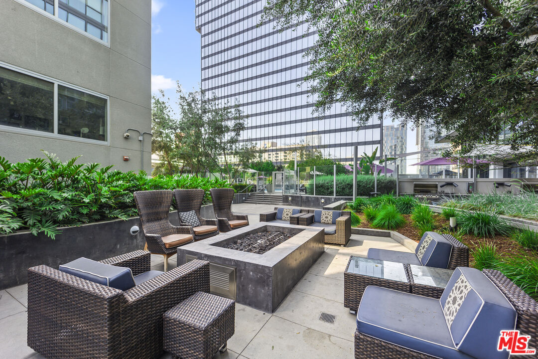 901 Flower Street, Unit 700 Los Angeles, CA 90015 - Photo 32 of 55 a view of a patio with couches table and chairs with plants and trees