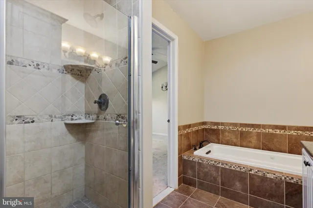 a bathroom with a tub and shower