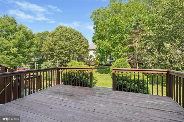 a view of balcony with wooden floor and fence