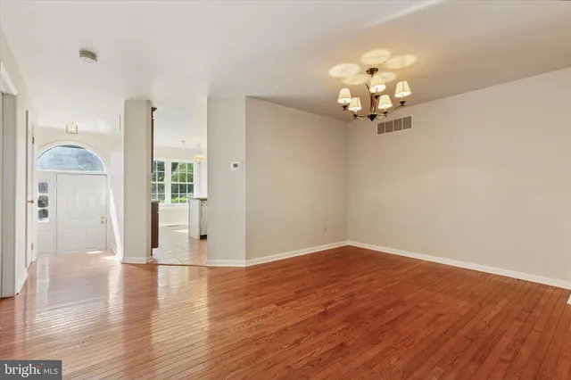 wooden floor in an empty room with a window