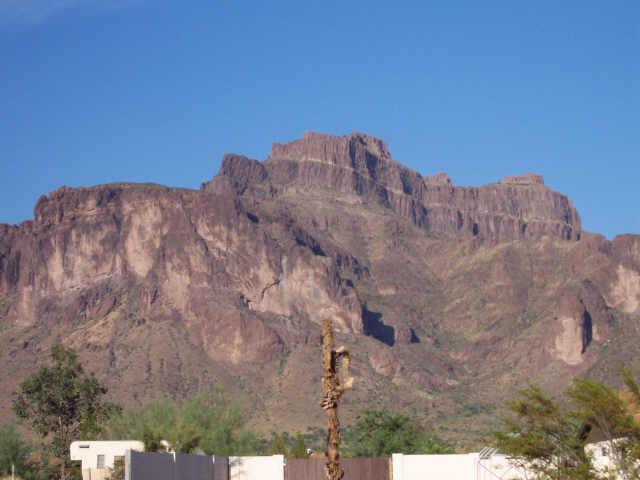 1025 North Boyd Road, Unit 24 Apache Junction, AZ 85119 - Photo 3 of 4 a view of a dry yard with mountains in the background