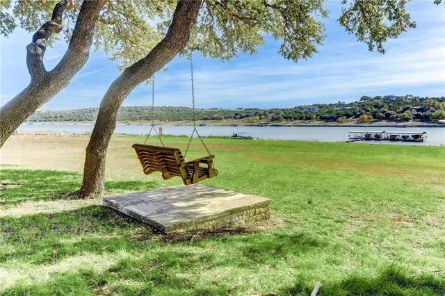 a view of a garden with a table and chairs