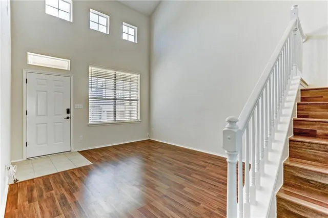 a view of an entryway with wooden floor and stairs